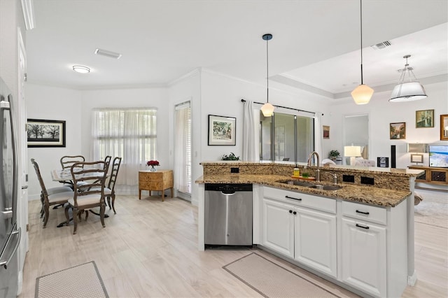 kitchen with pendant lighting, sink, stone countertops, stainless steel dishwasher, and white cabinets