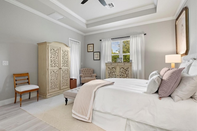 bedroom with ornamental molding, light hardwood / wood-style flooring, and ceiling fan