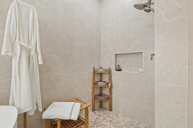 bathroom featuring tile walls and a tile shower