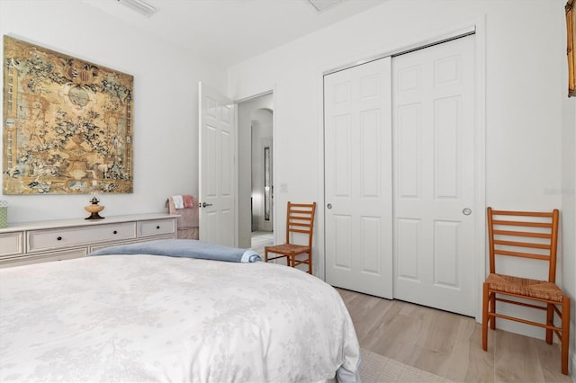 bedroom featuring light hardwood / wood-style flooring and a closet