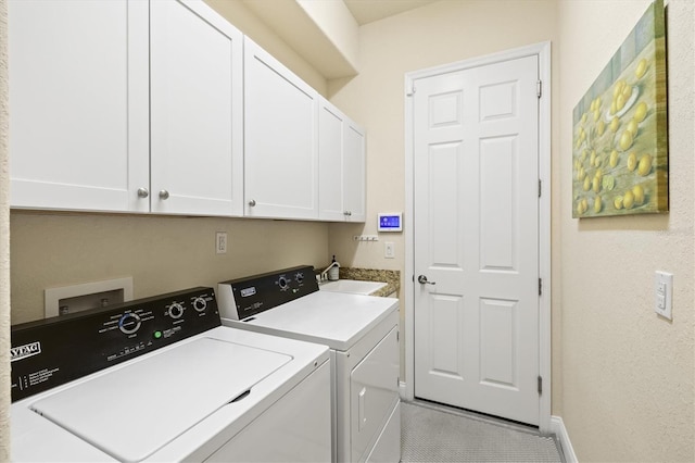 laundry room with sink, cabinets, and washer and dryer