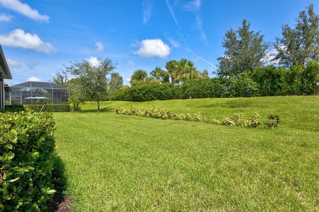 view of yard featuring glass enclosure