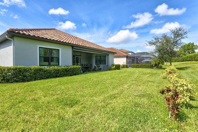 view of yard with glass enclosure