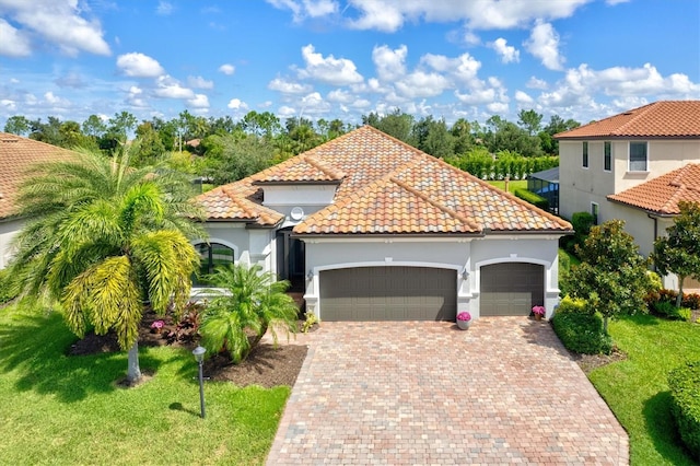 mediterranean / spanish home with a garage and a front yard