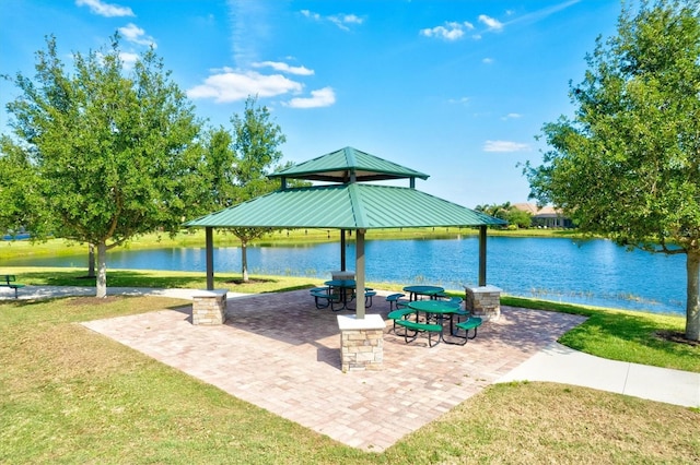 exterior space with a yard, a water view, and a gazebo