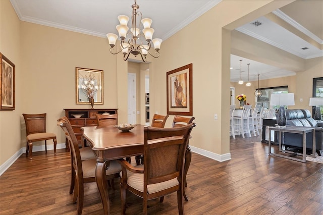 dining room with a notable chandelier, crown molding, and dark hardwood / wood-style flooring