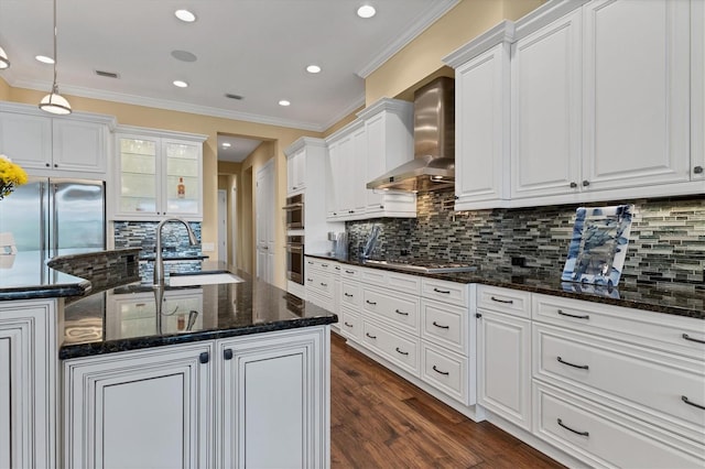 kitchen featuring white cabinets, backsplash, stainless steel appliances, and wall chimney exhaust hood