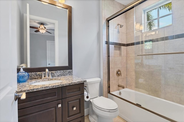 full bathroom with toilet, ceiling fan, ornamental molding, bath / shower combo with glass door, and vanity