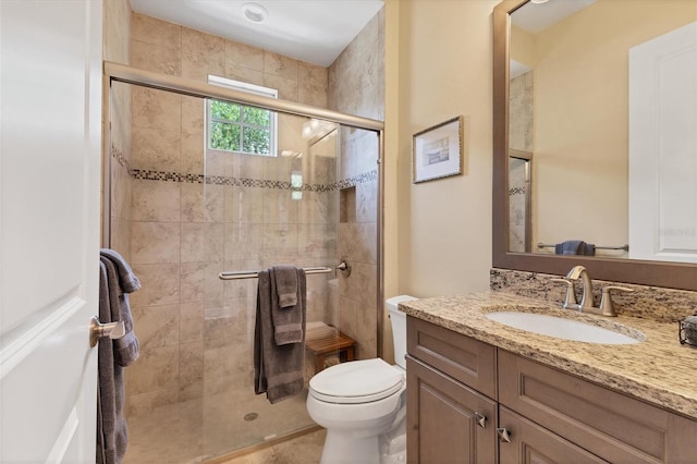 bathroom featuring walk in shower, toilet, tile patterned floors, and vanity