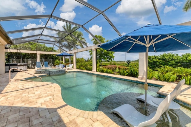 view of swimming pool with glass enclosure, an in ground hot tub, and a patio area