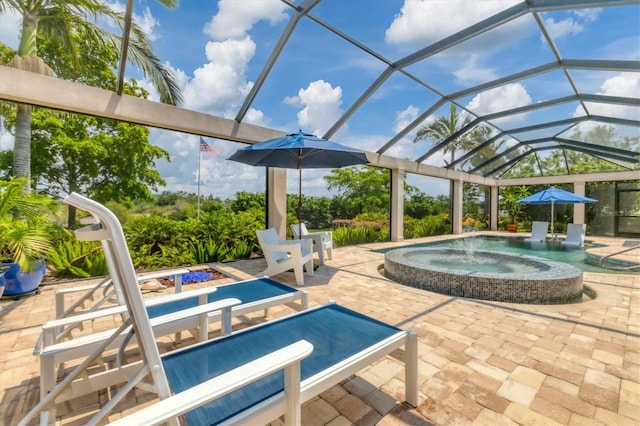 view of swimming pool with an in ground hot tub, a lanai, and a patio