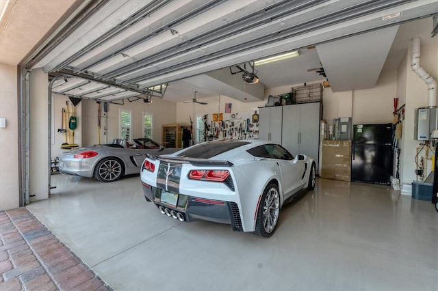 garage featuring a garage door opener, black refrigerator, and water heater