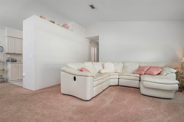 living room featuring light carpet and vaulted ceiling