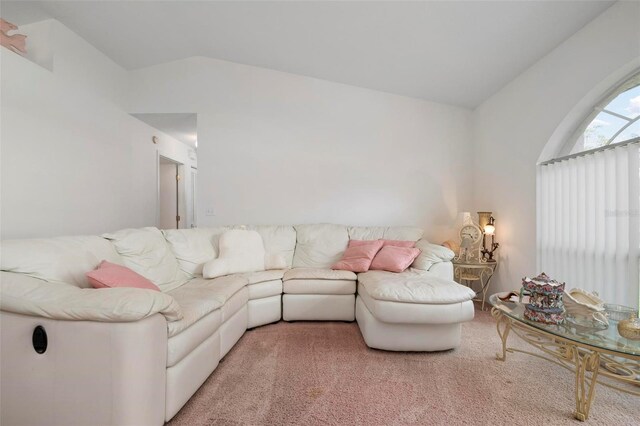 carpeted living room featuring lofted ceiling