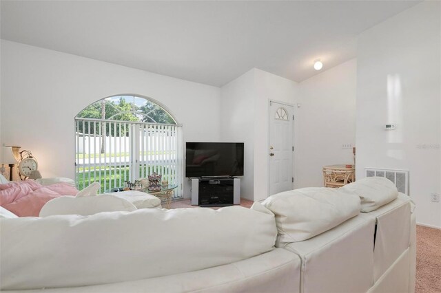 living room featuring lofted ceiling and carpet floors