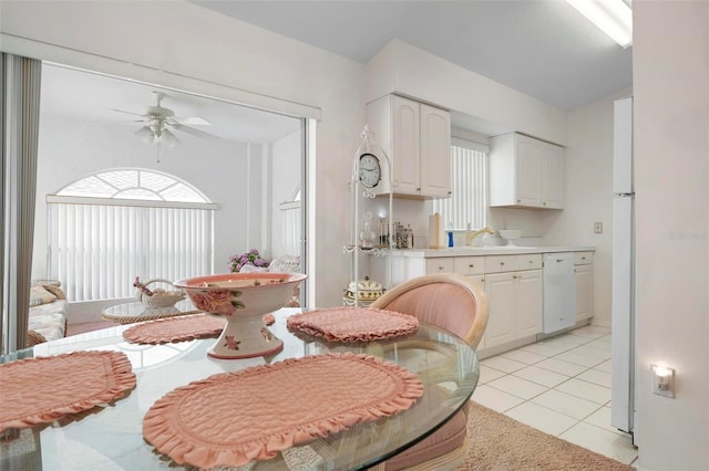 tiled dining room with sink and ceiling fan