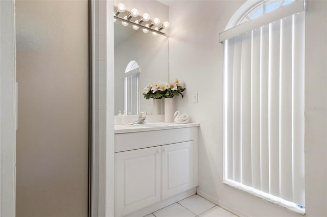 bathroom with vanity, walk in shower, and tile patterned flooring