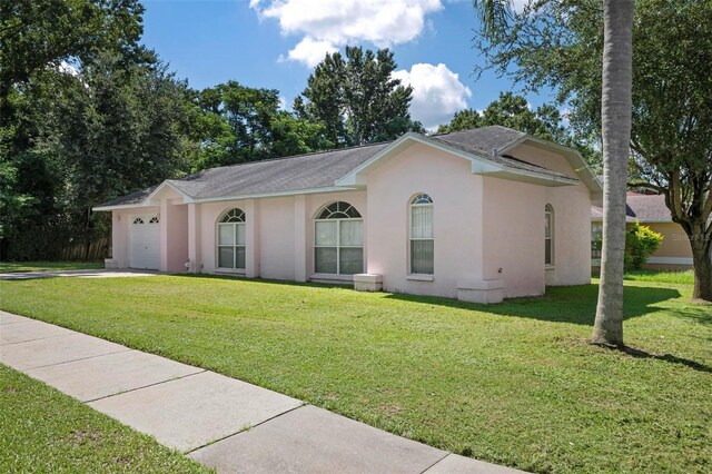 ranch-style house with a front yard and a garage