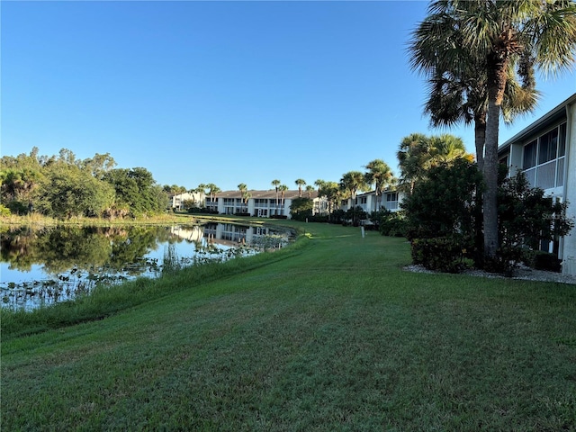 exterior space with a lawn and a water view