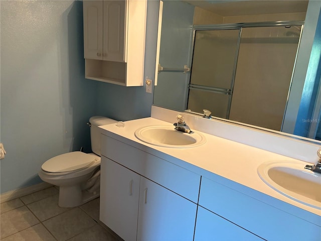 bathroom featuring tile patterned flooring, dual vanity, and toilet