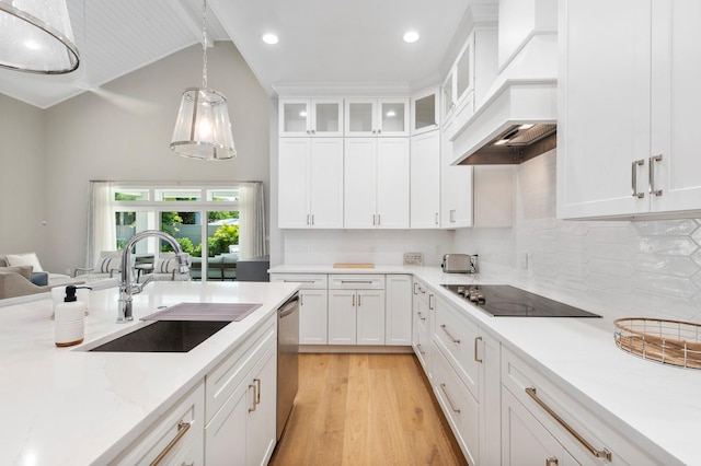 kitchen with lofted ceiling, light wood-type flooring, custom exhaust hood, decorative backsplash, and sink