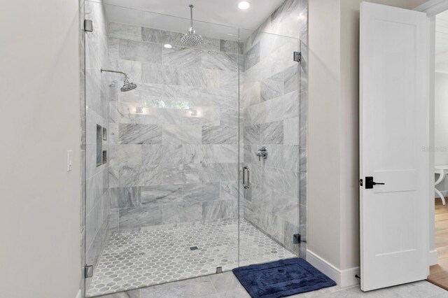 bathroom with wood-type flooring and a shower with door