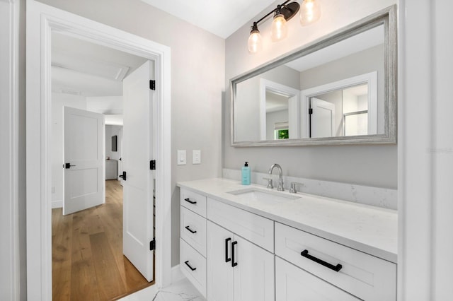 bathroom with hardwood / wood-style floors and vanity