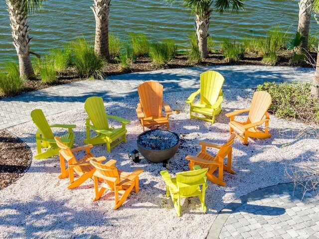 view of patio / terrace featuring a water view and an outdoor fire pit