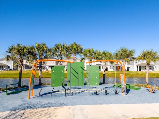 surrounding community with a playground and a water view