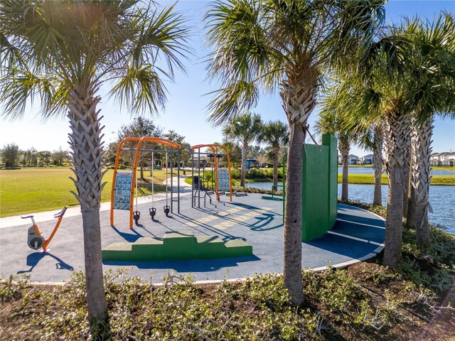 view of community featuring a playground and a water view