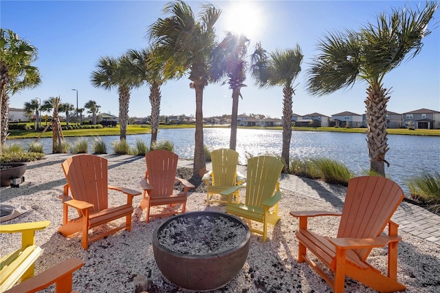 view of patio with a water view and an outdoor fire pit