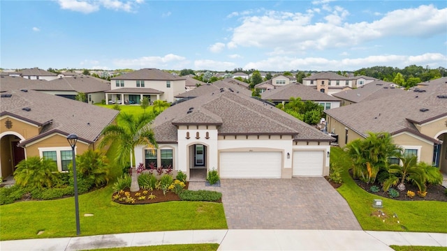 view of front of home with a front yard and a garage