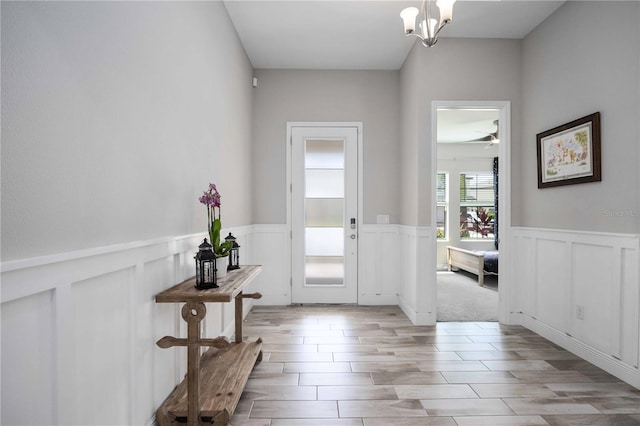 entrance foyer featuring light hardwood / wood-style flooring and an inviting chandelier