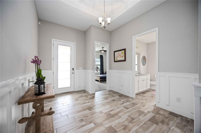 foyer with light wood-type flooring and a chandelier