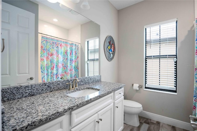 bathroom with toilet, hardwood / wood-style flooring, a shower with shower curtain, and vanity