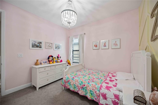 carpeted bedroom featuring a notable chandelier