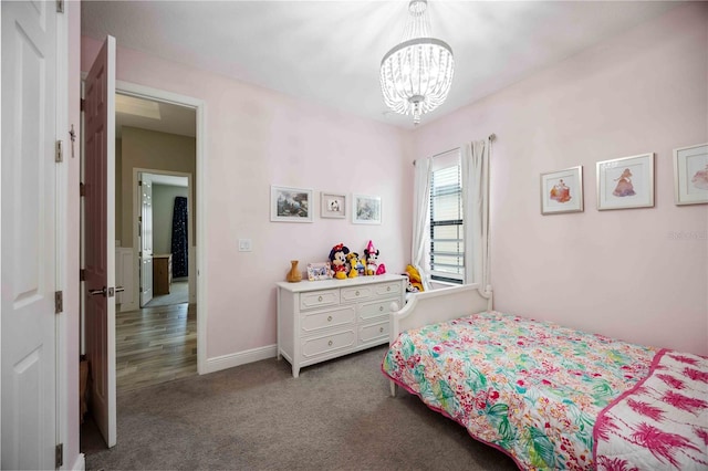 carpeted bedroom featuring a notable chandelier