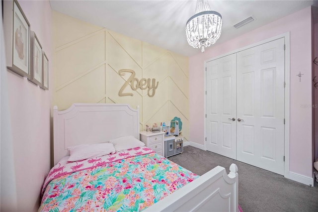 carpeted bedroom featuring a closet and a notable chandelier