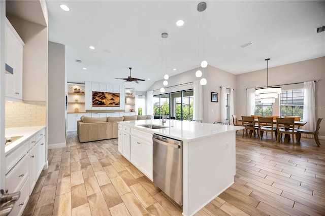 kitchen with dishwasher, an island with sink, decorative light fixtures, sink, and white cabinetry