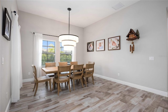 dining area with light hardwood / wood-style floors