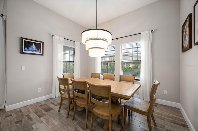 dining room with hardwood / wood-style flooring and a notable chandelier