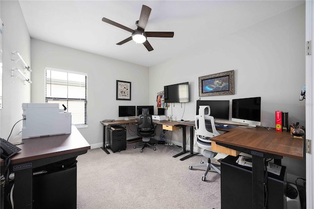 carpeted office space with ceiling fan