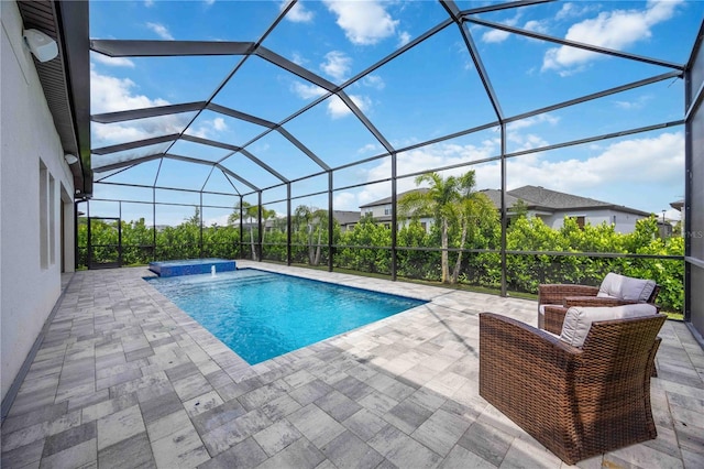 view of swimming pool with an in ground hot tub, glass enclosure, and a patio