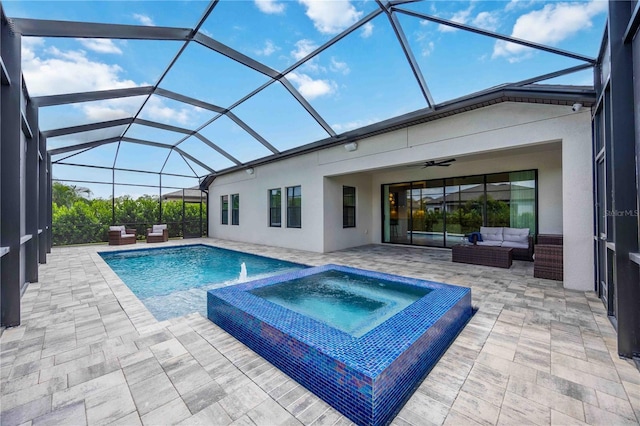 view of pool featuring a patio, an in ground hot tub, an outdoor hangout area, and glass enclosure