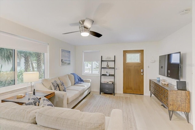 living room featuring a ceiling fan and light wood-style flooring