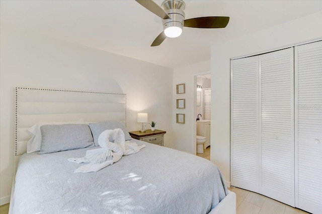 bedroom featuring a closet, ensuite bathroom, and a ceiling fan