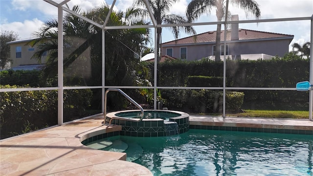 view of swimming pool with an in ground hot tub and glass enclosure