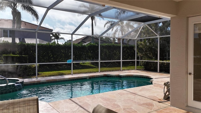 view of pool with an in ground hot tub, a lanai, and a patio