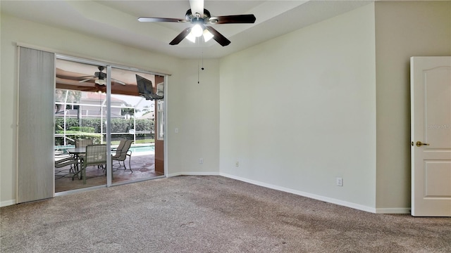 spare room featuring ceiling fan and carpet floors