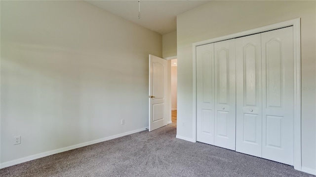 unfurnished bedroom with carpet floors and a closet